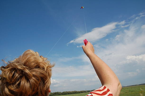 Mom Riding the Kite stock photo