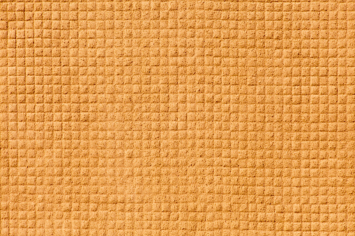 Yellow, brown wall, old-fashioned small tiles suitable for backgrounds purposes. Gresite.