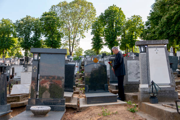 istock Mature man mourning a deceased loved one on cemetery. 1399729512