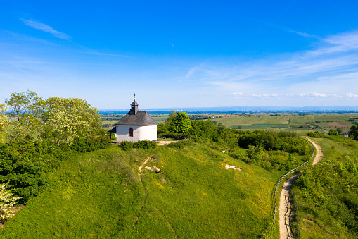 Aerial view from nature reserve\nthe little Kalmit. Is located in the east of the Palatinate Forest near the wine and holiday resort of Ilbesheim. A small chapel on the hilltop. Rhinland-Palatinate