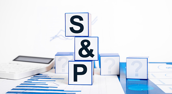 SP 500. Stock market, investment and finance concept. Cubes with Standard and Poor index abbreviation, calculator and graphs. High quality photo