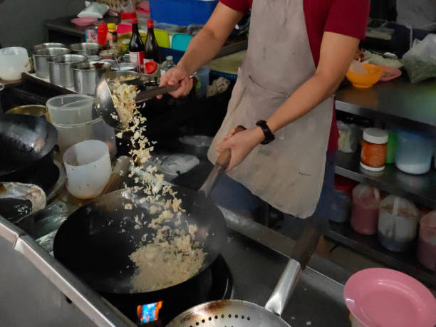 Success An Asian man is running own restaurant - focus in cooking Chinese fried rice successfully. chinese cuisine fried rice asian cuisine wok stock pictures, royalty-free photos & images