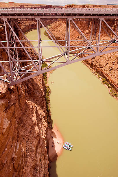 Navajo Bridge and river rafts stock photo
