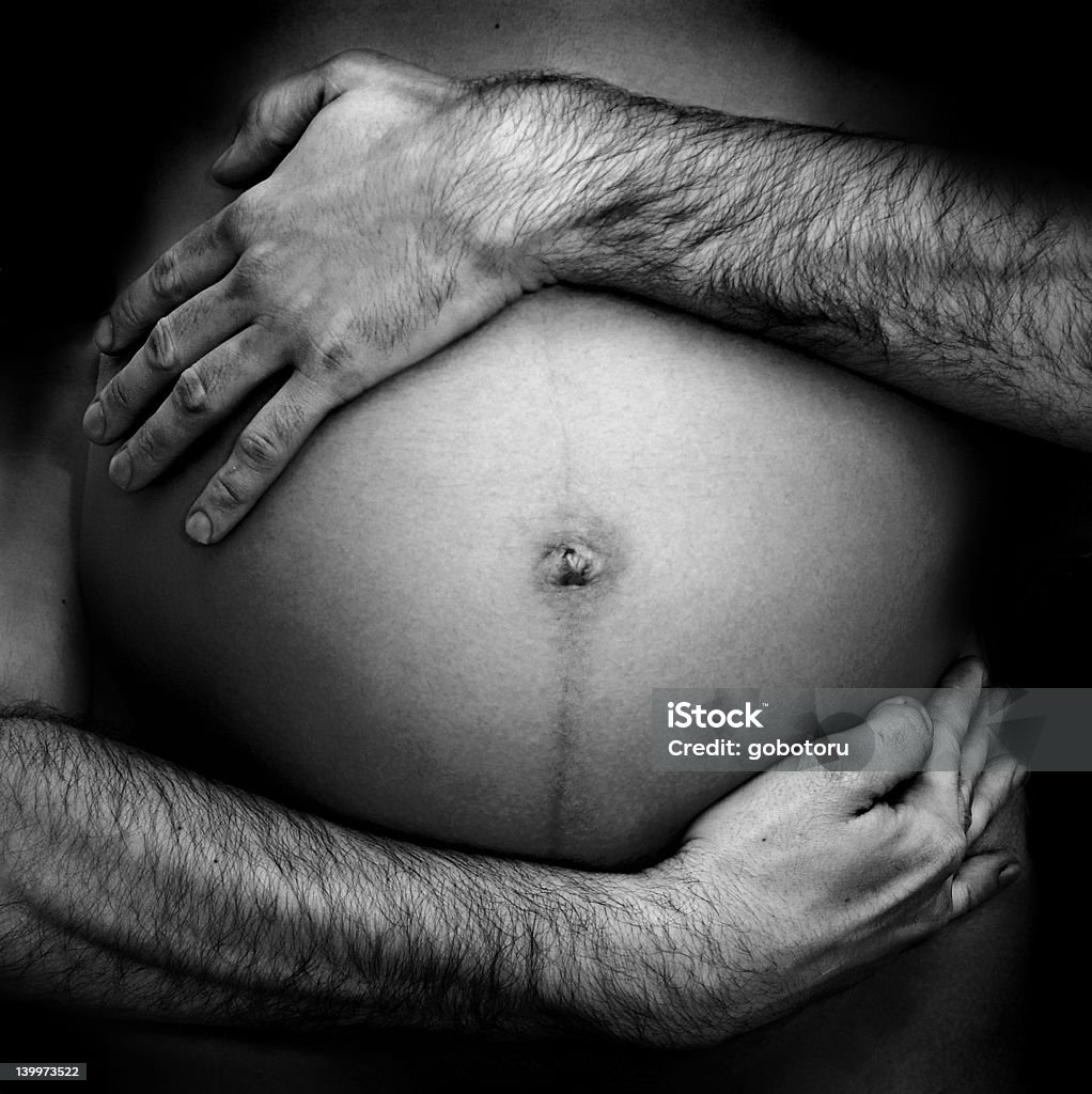 hairy hands around belly 2 hands holding mother's belly Adult Stock Photo