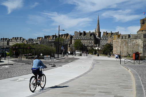 Saint-Malo, France, May 11, 2022: Cyclist riding on a Saint-Malo cycle path