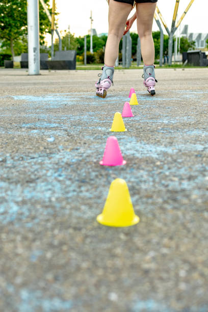A yellow and black roller skate with red wheels. The skate is in the middle of the image