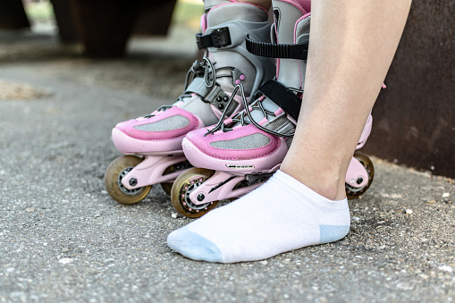 Woman on park putting on skates getting ready to have fun