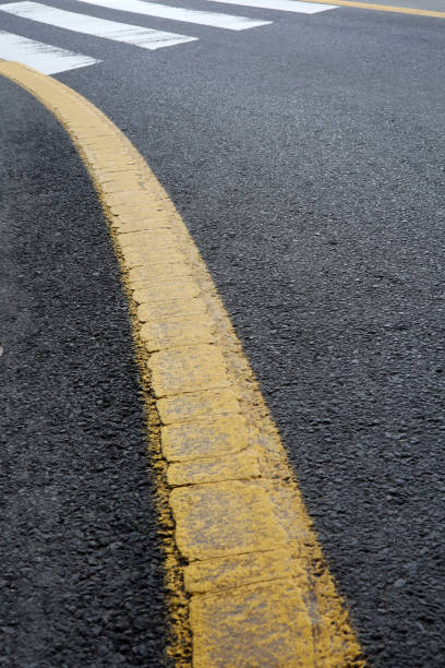 istock white and yellow lines on asphalt background 1399737228