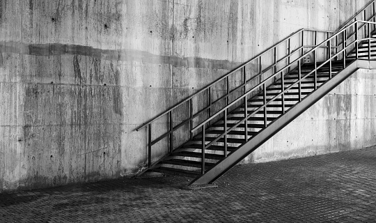 black and white old metal stairs of concrete wall
