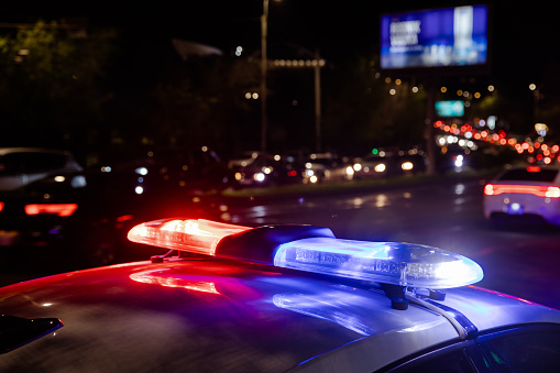 police car lights at night in city background