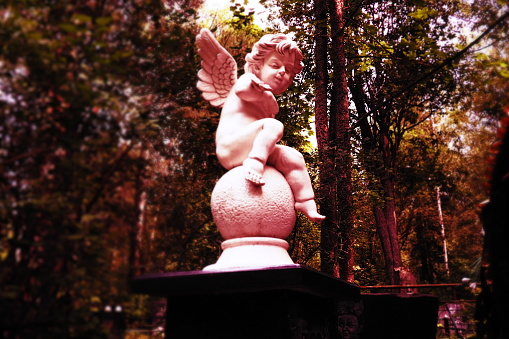 Angel in the cemetery monument at the grave of a child sculpture in the form of an angel.
