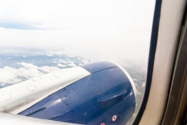 istock View out of an airplane window at an engine 1399739201