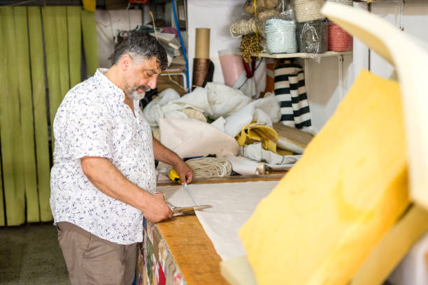 istock Man works on a upholstery leather factory 1399743025