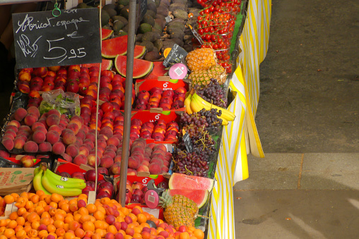 Sale of summer fruits with a price board.