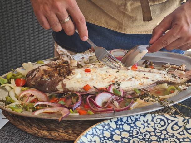 istock Waiter splitting fish, Canarian sama. 1399745158