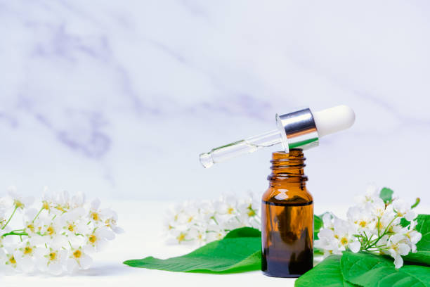 istock Apple blossom essential oil in a bubble with a pipette on a white marble background, copy space 1399747754