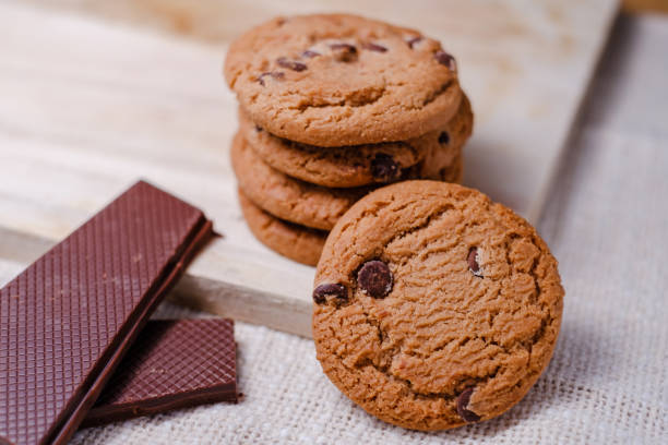 istock Crispy choco chips on a wooden table on a pastel color background 1399751055