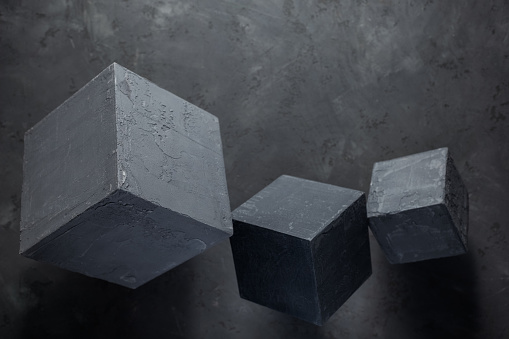 Cement block at floor background as construction concept. Concrete cube with abstract art idea