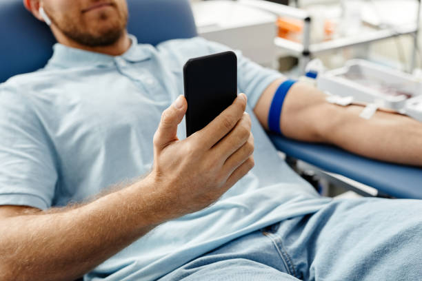 istock Man Watching Videos in Blood Donation 1399755104