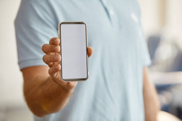 istock Man Holding Blank Smartphone 1399755106