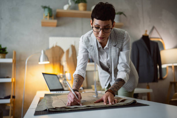 istock Creative Caucasian female tailor outline the pattern on the textile 1399756760