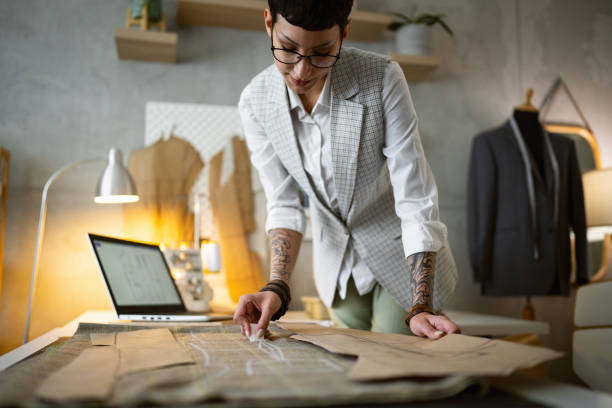 istock Caucasian female tailor outline with chalk pattern on the textile 1399757522
