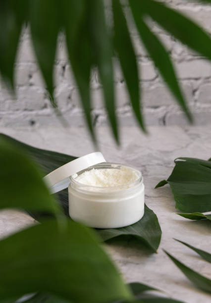 istock White jar and monstera leaves on marble table close up. Brand packaging mockup 1399757803