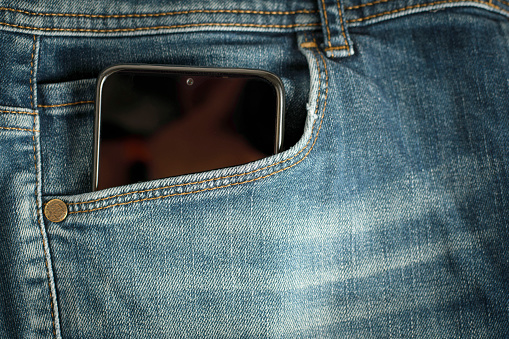 mobile smartphone in jeans pocket