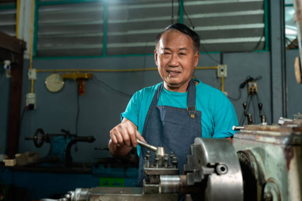 istock A senior craftsman who is skilled in craftsmanship, is controlling, skillfully operating a lathe, is in a small factory that is his family business. 1399760125