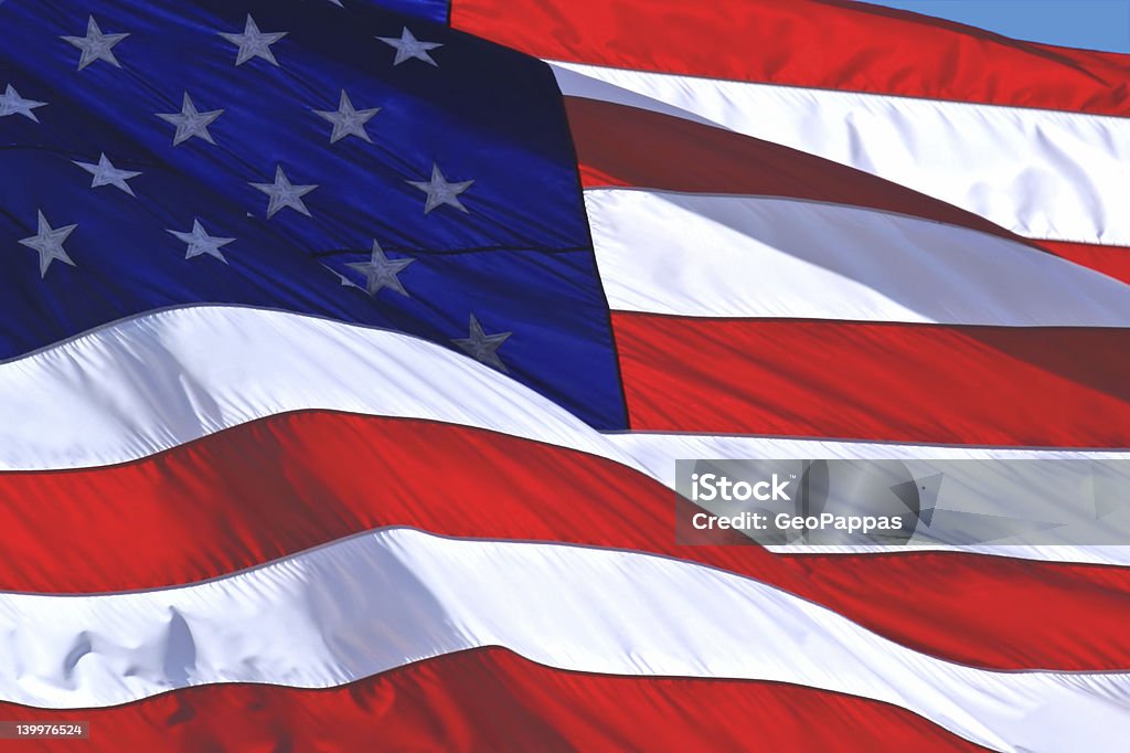 American Flag Photo of a U.S. flag blowing in the wind American Culture Stock Photo