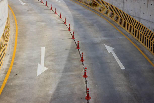 istock Arrow symbols and orange bollards or delineators on road. 1399766055