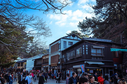 Miyajima, Japan - January 02, 2020: Crowded by Local People and Walking Tourists the main  Itsukushima street