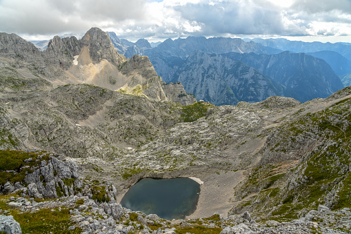 High angle view on Upper Krisko Lake in the heart of mountain peaks in Triglav national park, Julian Alps