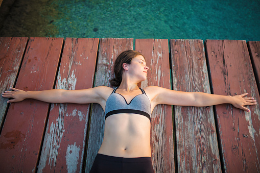 Woman stretching by the lake