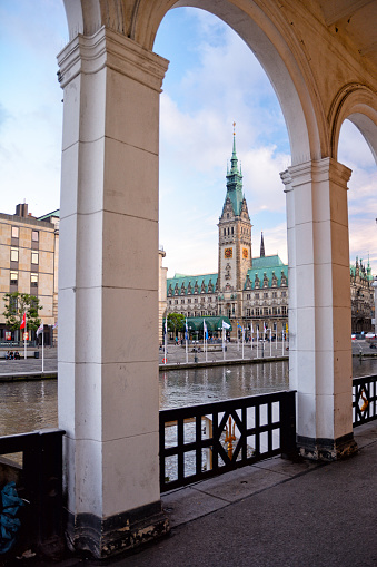 View of the Hamburg City Hall seen across the Kleine Alster from Alster Arcades at sunset, Germany