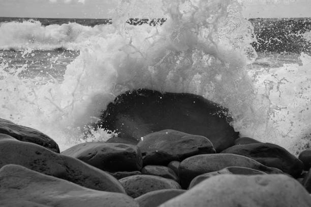 istock A Turquoise wave breaking on a beach in sea with silver clouds 1399772551