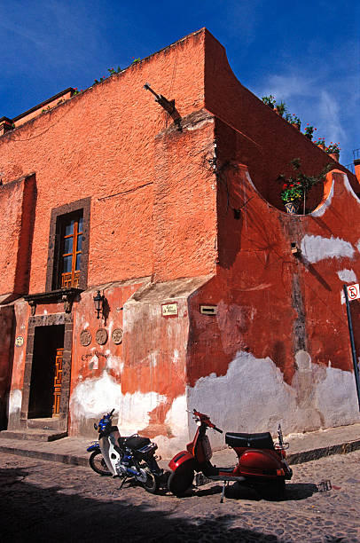 San Miguel Street Corner Series One of the most popular modes of transportation in San Miguel de Allende are motor scooters due to the narrow Colonial Era streets. san miguel de cozumel stock pictures, royalty-free photos & images