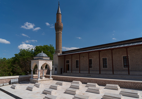 Konya, Turkey - May 12, 2022: Alâeddin Mosque was built in the 13th century during the Anatolian Seljuk period. Sultan II Kilicarslan Tomb is located in the courtyard of the mosque.