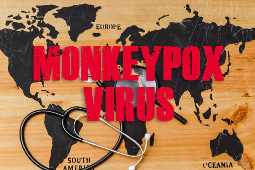 Monkeypox is caused by monkeypox virus.Smallpox is a viral zoonotic disease. Virus transmitted to humans from animals.Inscription world wooden map,a stethoscope and a magnifying lip lie on the map.
