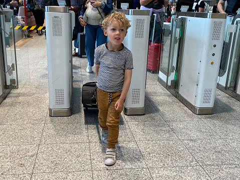 Toddler boy traveling by plane with his parents