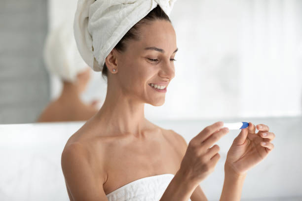 istock Happy curious beautiful hispanic woman holding pregnancy test. 1399779295