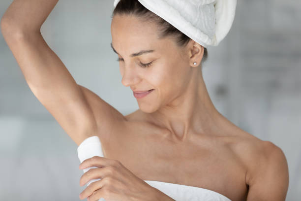 istock Happy young mixed race woman applying deodorant. 1399779306