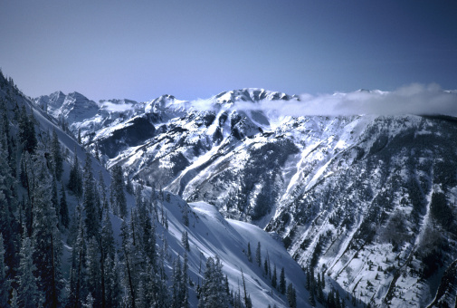 Photo of snow capped mountains in Aspen Colorado during wintertime.  Maroon Bells can be seen on the left in the background.