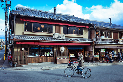 Arashiyama, Japan - January 03, 2020: Local Man on the Bicycle in Arashiyama district near Bamboo Forest