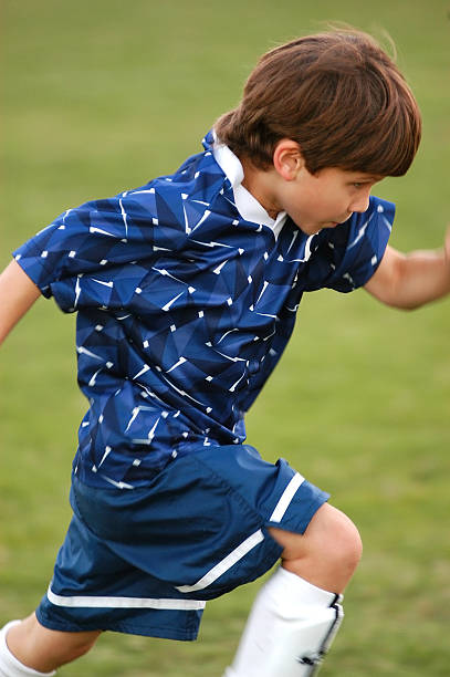 istock Boy running in soccer game 139978196