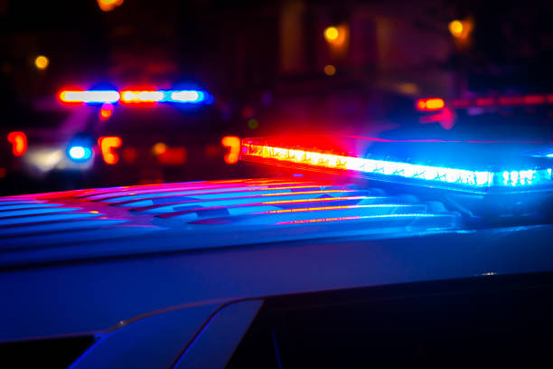 Red and blue police lights in city Red and blue police lights near a car crash in a city at night. morder stock pictures, royalty-free photos & images