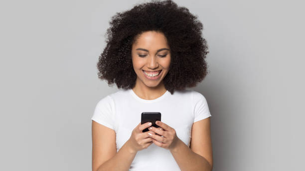 istock Smiling African American woman use smartphone texting online 1399785522