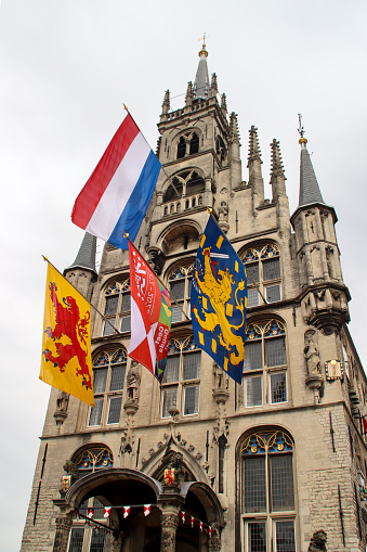 Flags on the ancient town hall at the Markt of Gouda during celebration of 750 years Gouda in the Netherlands