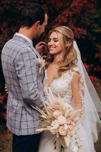 istock Happy bride and groom with boho bouquet in autumn 1399786439