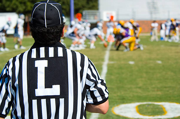 American Football played by young men with game official linesman referee